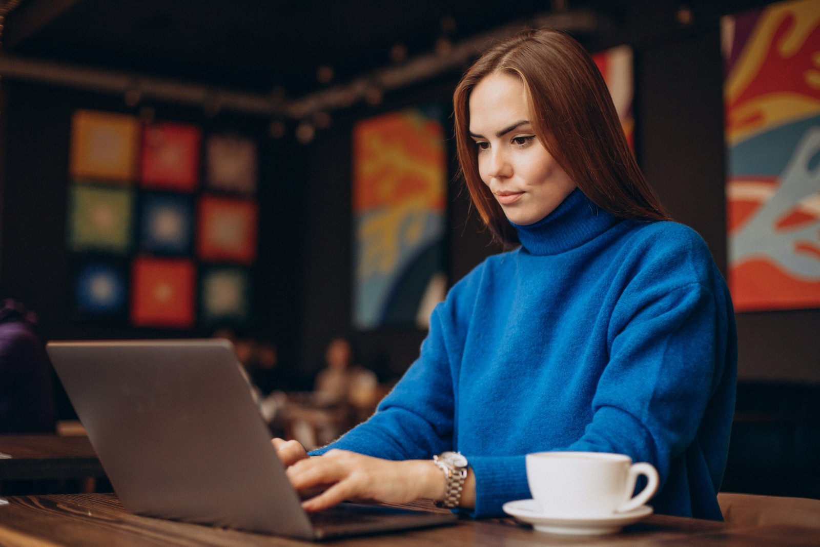 Business woman working on laptop in a cafe Business woman working on laptop in a cafe
